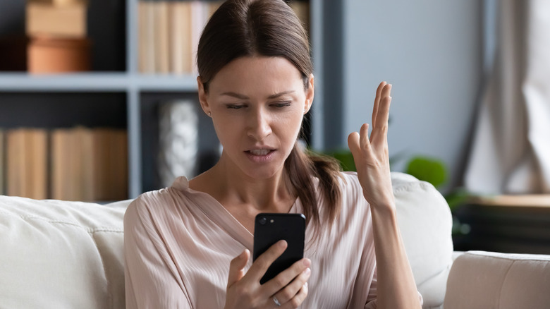 woman looking at phone intensely 