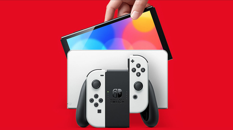 Nintendo Switch OLED red background with white dock and Joy-Cons