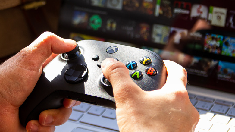 Hands holding Xbox controller