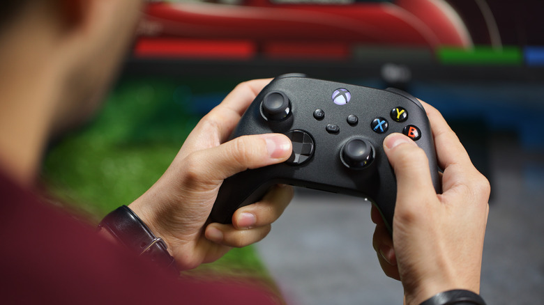 Person holding Xbox controller