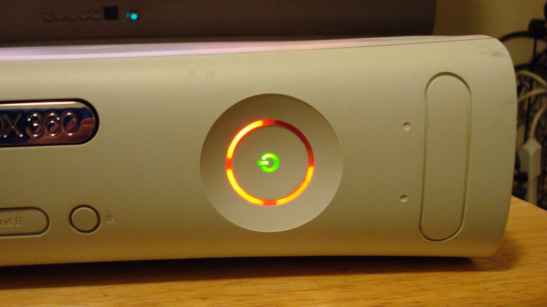 Close up of Red Ring of Death lights on an Xbox 360 console power button
