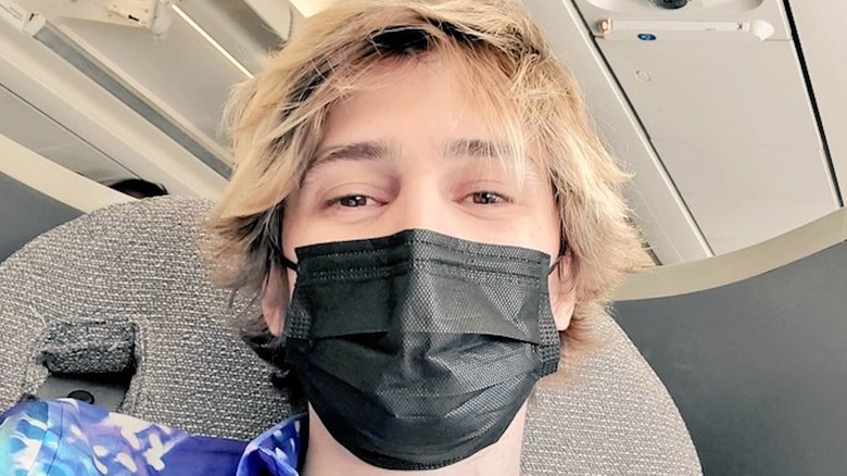 xQc wearing a mask on a plane